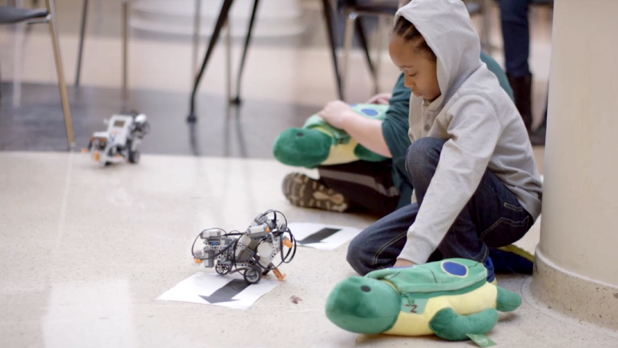 A child playing with a robot